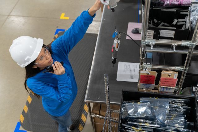 Woman speaking on two way radio with Nitro CBRS - Motorola Solutions